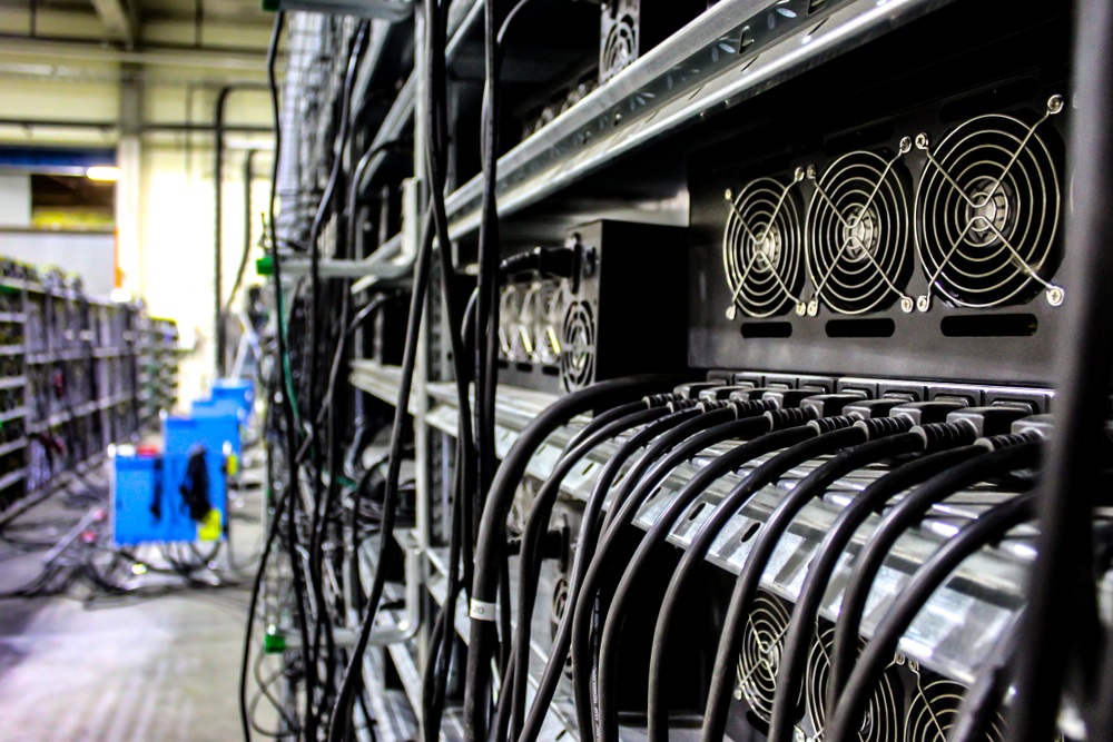 bitcoin mining asics on rack in mining facility 