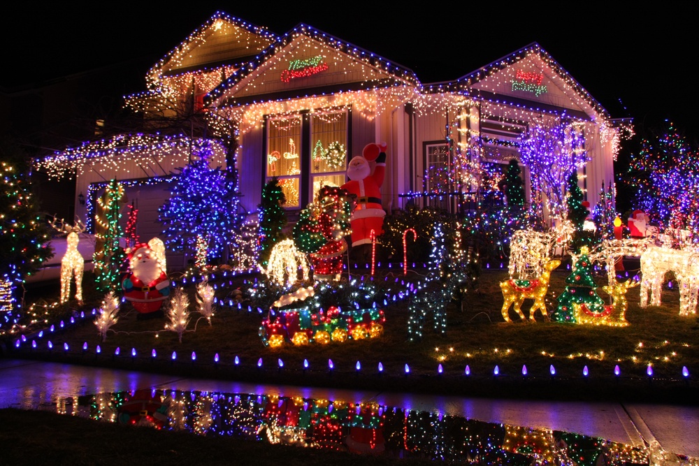 modern house with lots of blue and white Christmas lights wasting energy 