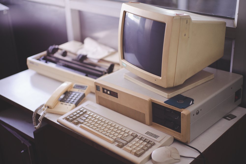 vintage computer from the 90 's with floppy disc, disc drive, fax machine, landline, and 3-click mouse