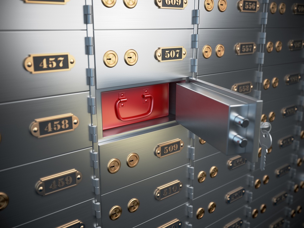 safety deposit boxes in a bank, where number 508 is open and showing a red box behind the door 