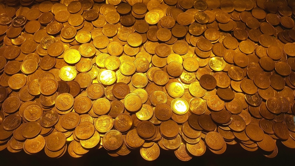 gold colored game tokens in pile 