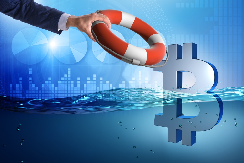 An illustration of the bitcoin symbol floating in water with graphs in the background and someone holding out a life preserver to it.  