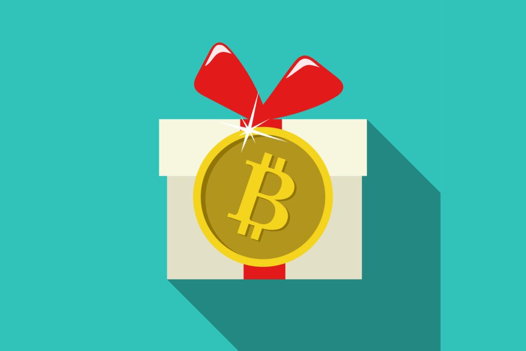 bitcoin gifts. A cartoon present with a red bow and a bitcoin on top of it 