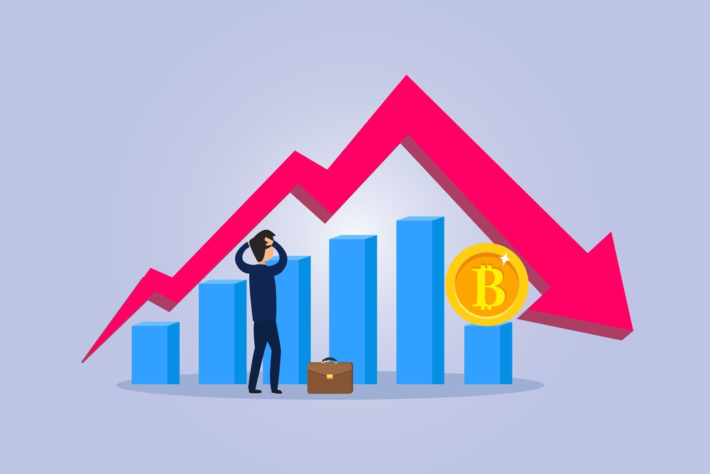 A cartoon business man looking in despair at a graph showing how bitcoin prices have increased and then decreased.  