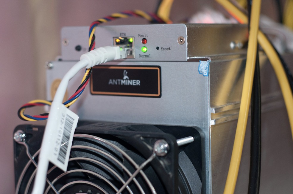 close photo of antminer bitcoin miner showing details of asic, including fan and wiring 