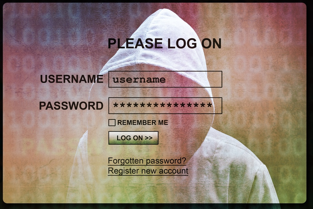 account username and password screen with hooded hacker figure layer to imply account was hacked 