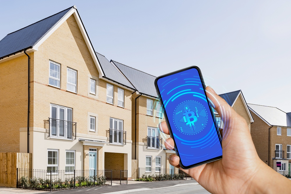 bitcoin logo on mobile phone with nfc technology. Background is a row of houses in the suburbs 