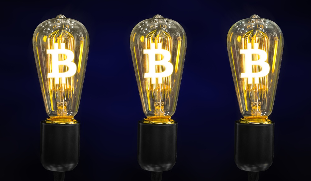 Three old-fashioned light bulbs standing independently, each with a bitcoin logo in it  