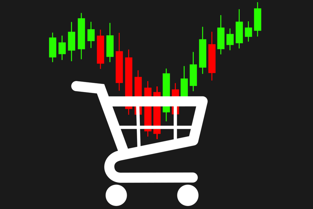 buy the bitcoin dip. candle stick chart with red price reversal landing in shopping cart then green candles moving out of cart, meaning to buy the price dip 