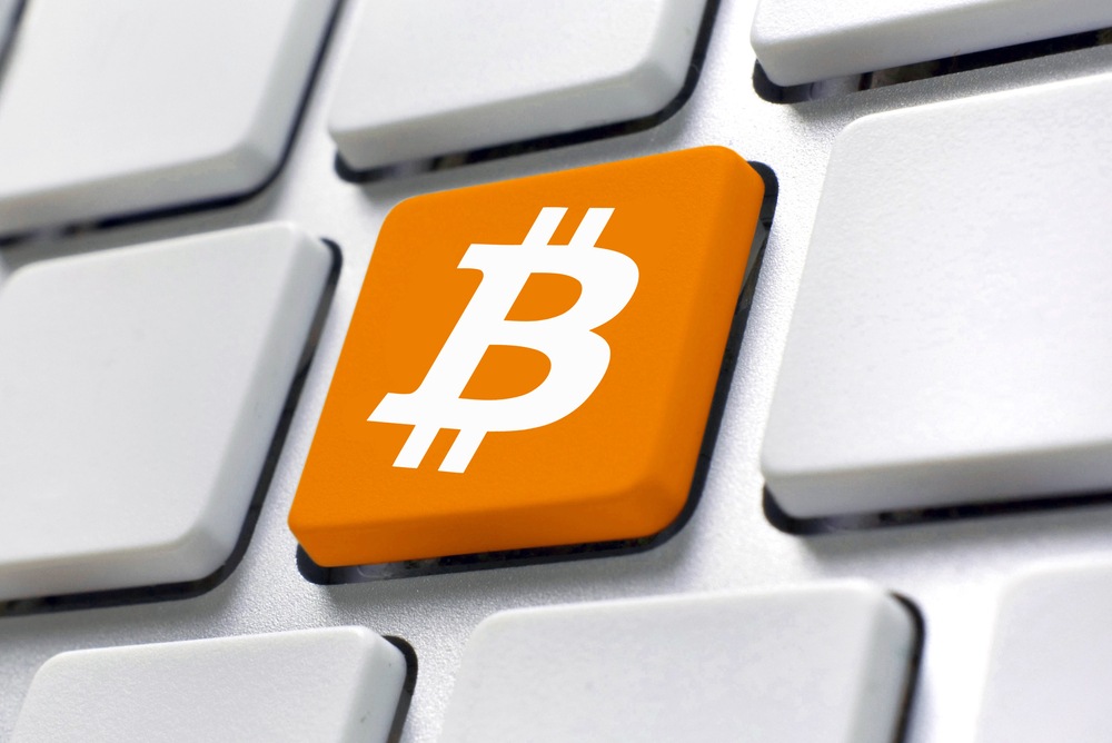 how to type the bitcoin symbol. orange bitcoin key on white keyboard 