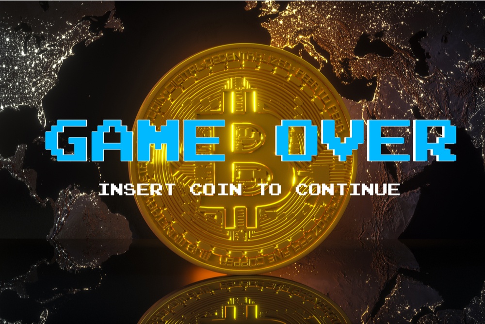 bitcoin coin with retro pixel writing that says  "game over".