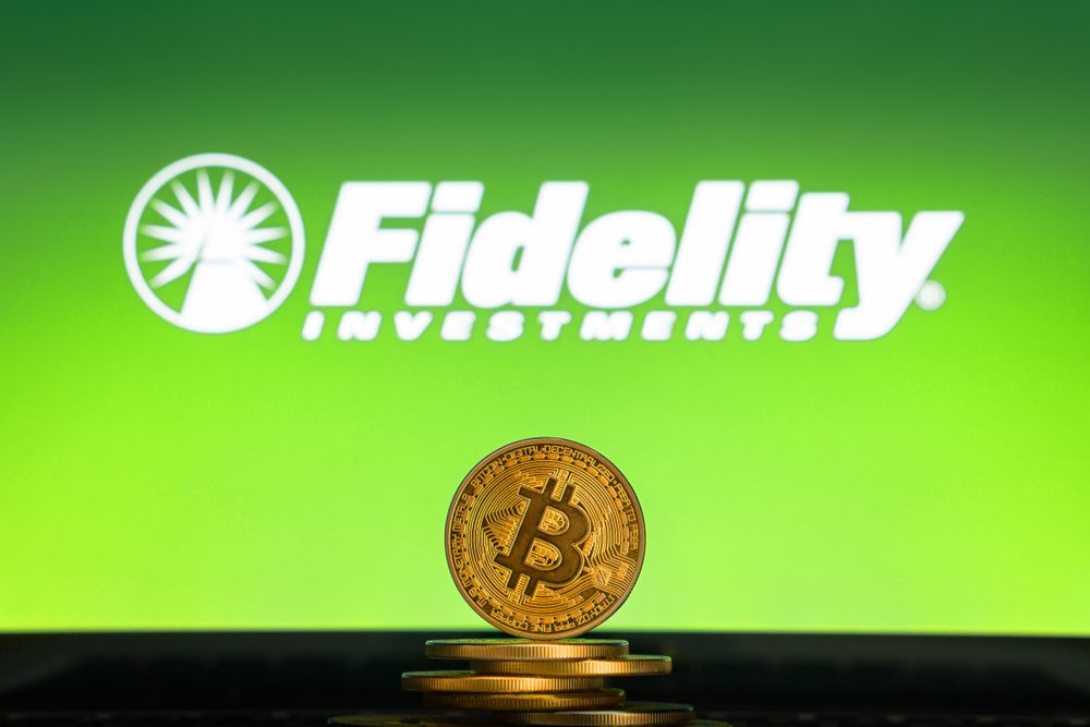 The logo for Fidelity Investments with a few physical bitcoins 