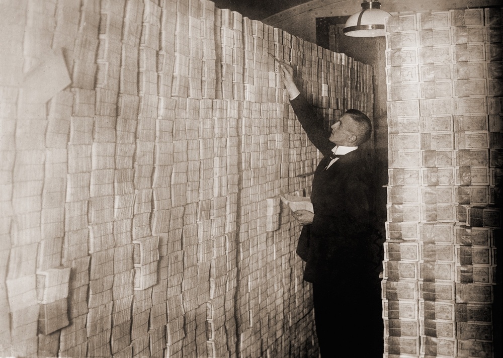 bricks of worthless paper money from the weimar republic stacked up taller than a grown man 