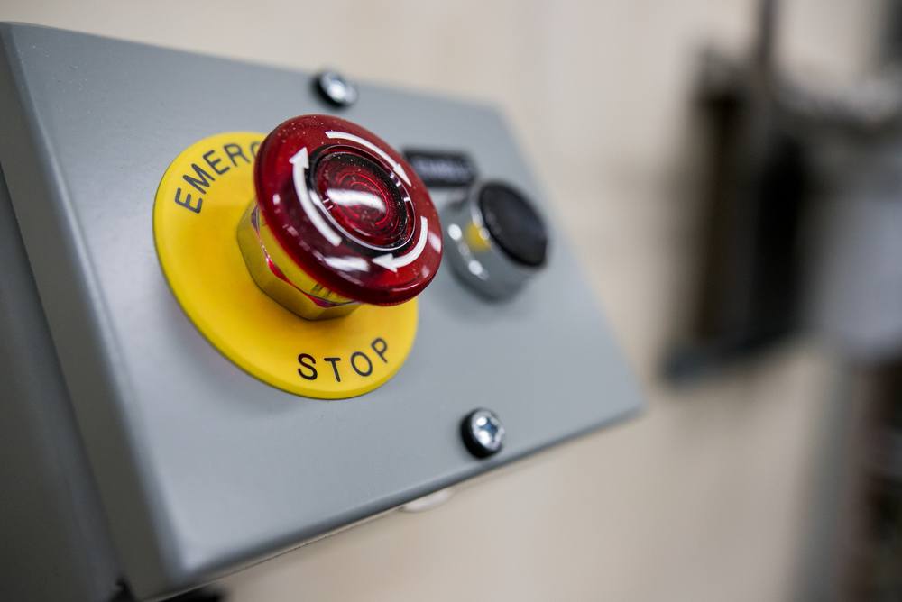 big red emergency stop button on industrial electrical panel. Can the government ban bitcoin with the flip of a switch? (No) 