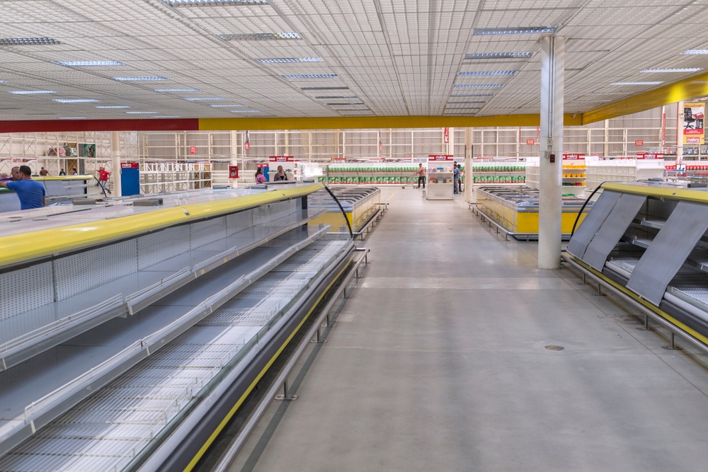 empty shelves in the grocery store in Venezuela. Food shortages were caused by government price restrictions as a result of hyperinflation 