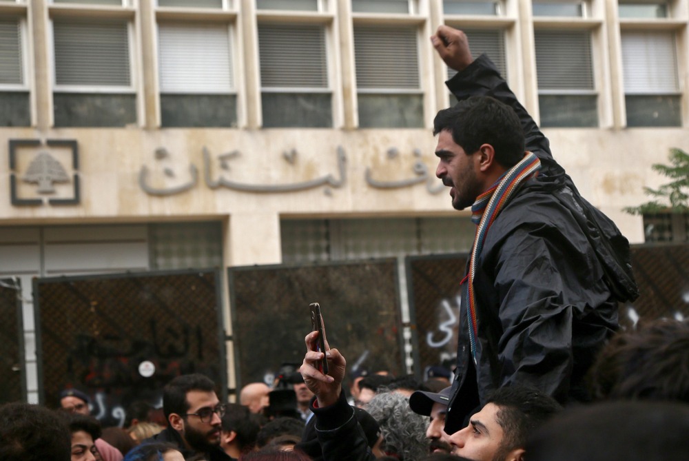 man shaking fist in anger during a protest in front of a bank in lebanon. Lebanon has an inflation rate of 215% 