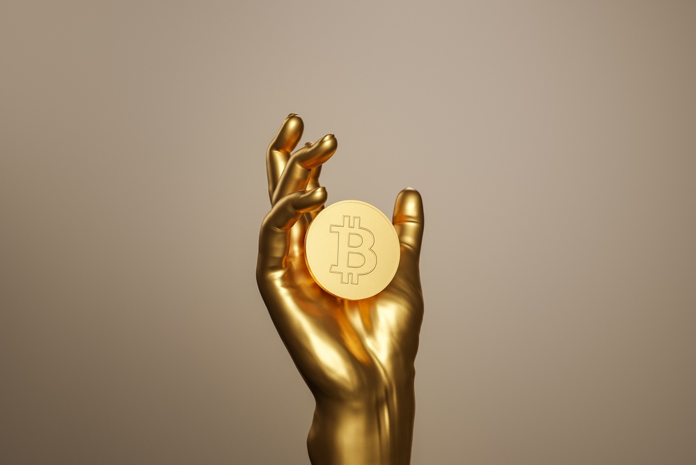 gold plated hand holding bitcoin 