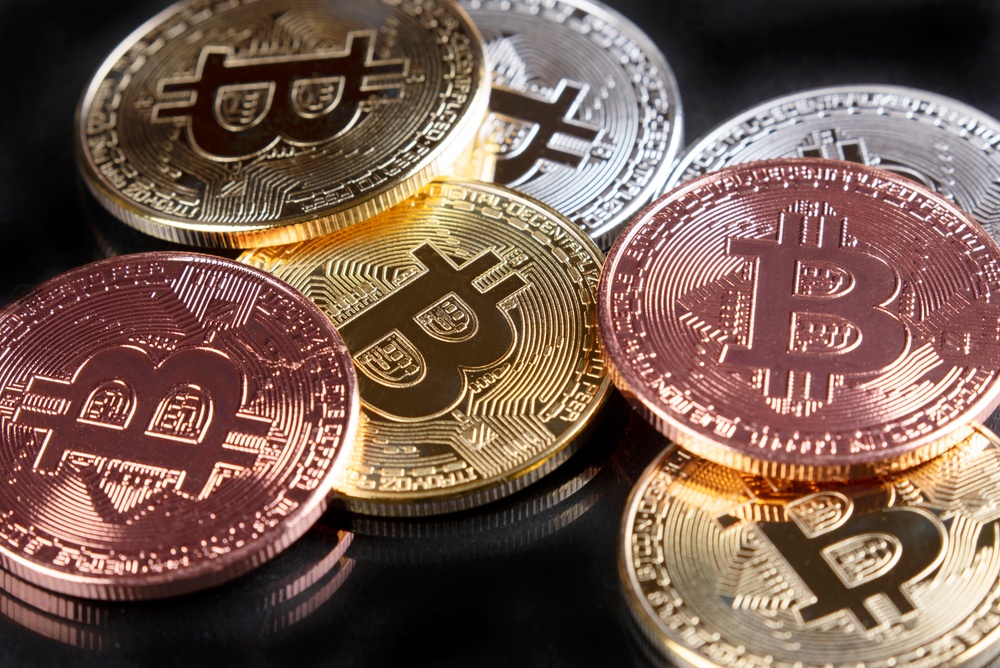 copper, silver, and gold colored physical bitcoins 