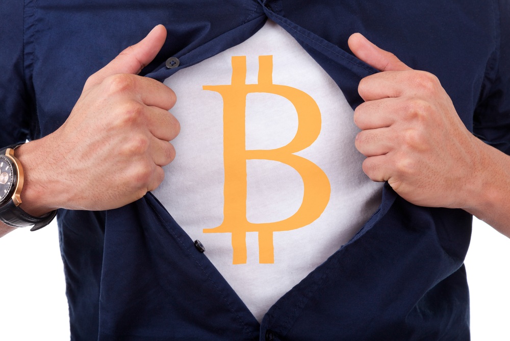 bitcoin logo on t-shirt hidden under blue button up shirt. opening shirt superman style 