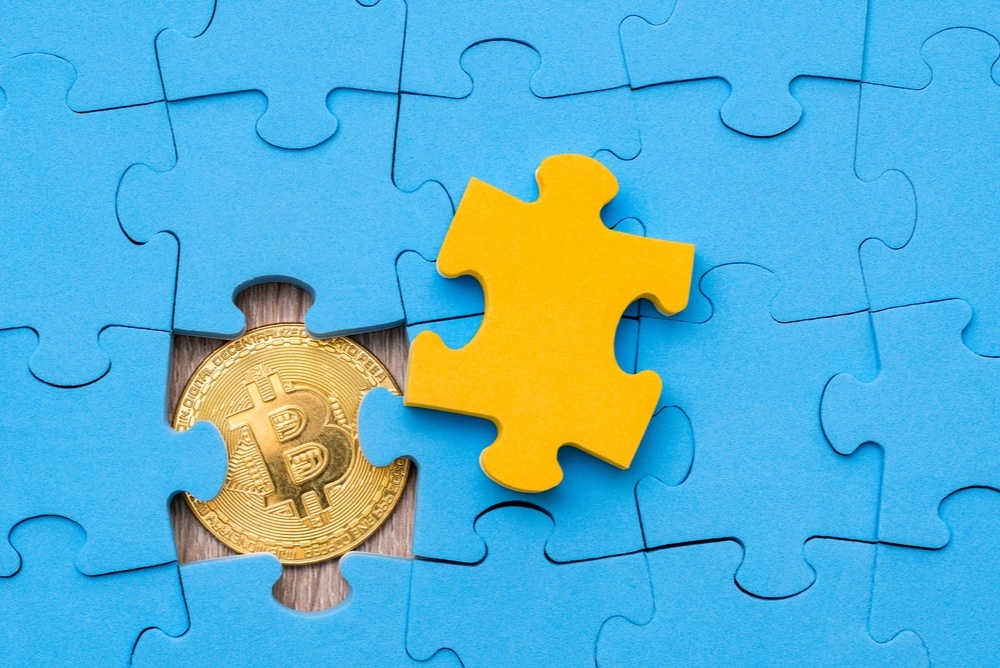 blue puzzle pieces with yellow puzzle piece removed, revealing a bitcoin. doing microtasks to earn bitcoin 