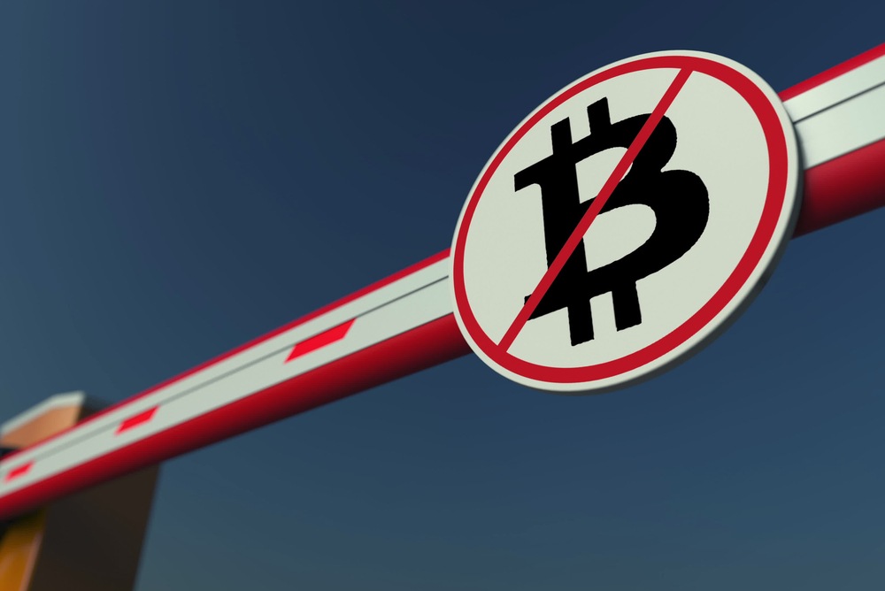 red cross arm blocking path with bitcoin logo. ban bitcoin 