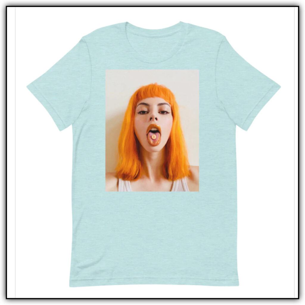 A green-gray shirt with an image of an orange haired woman with her tongue out and a bitcoin on her tongue 