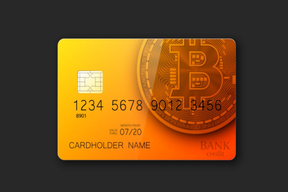 orange and yellow bank card with bitcoin logo 