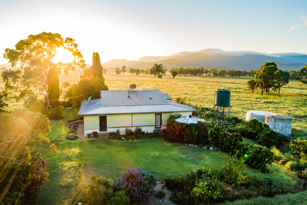 homestead and ranch with water tower, garden, and land 