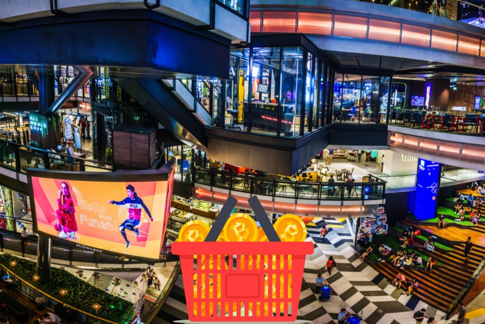 full color fish eye view of large indoor shopping centers with shopping basket full of bitcoins. shopping with a bitcoin debit cards 