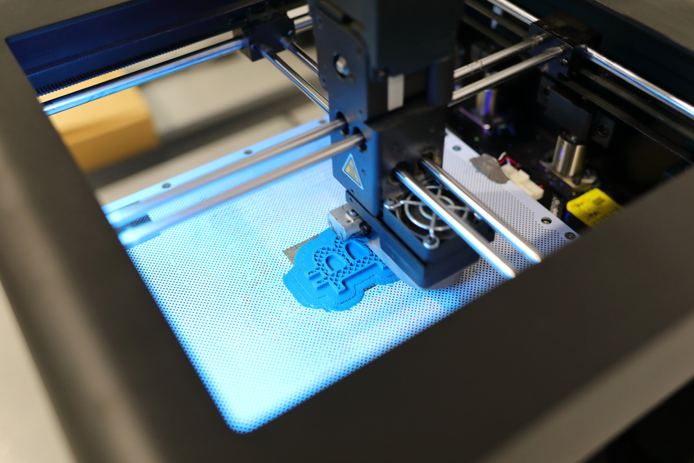 make money with bitcoin. 3d printer printing blue bitcoin logo from plastic 