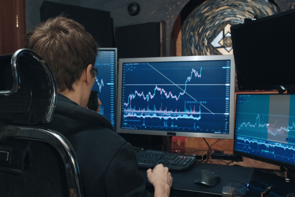 bitcoin trader analyzing the candlestick chart and doing technical analysis of a trend line 