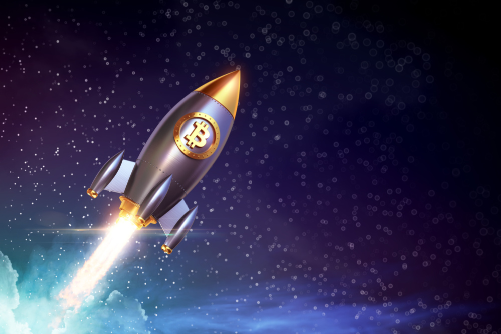 gold and silver rocket shooting into space with bitcoin logo 