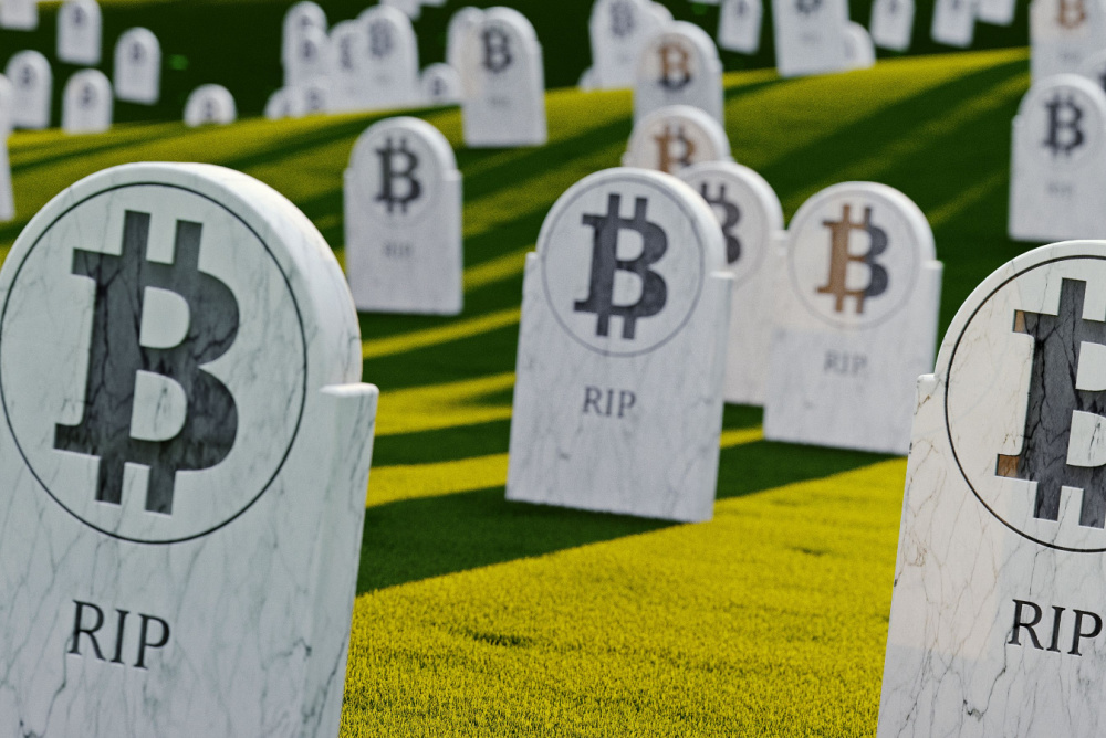 is bitcoin dead? bitcoin logo on marble graves in green grass cemetary 