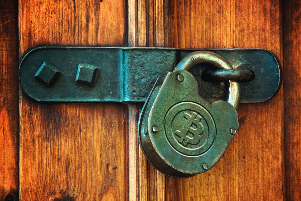 rustic lock with bitcoin logo on wooden door 