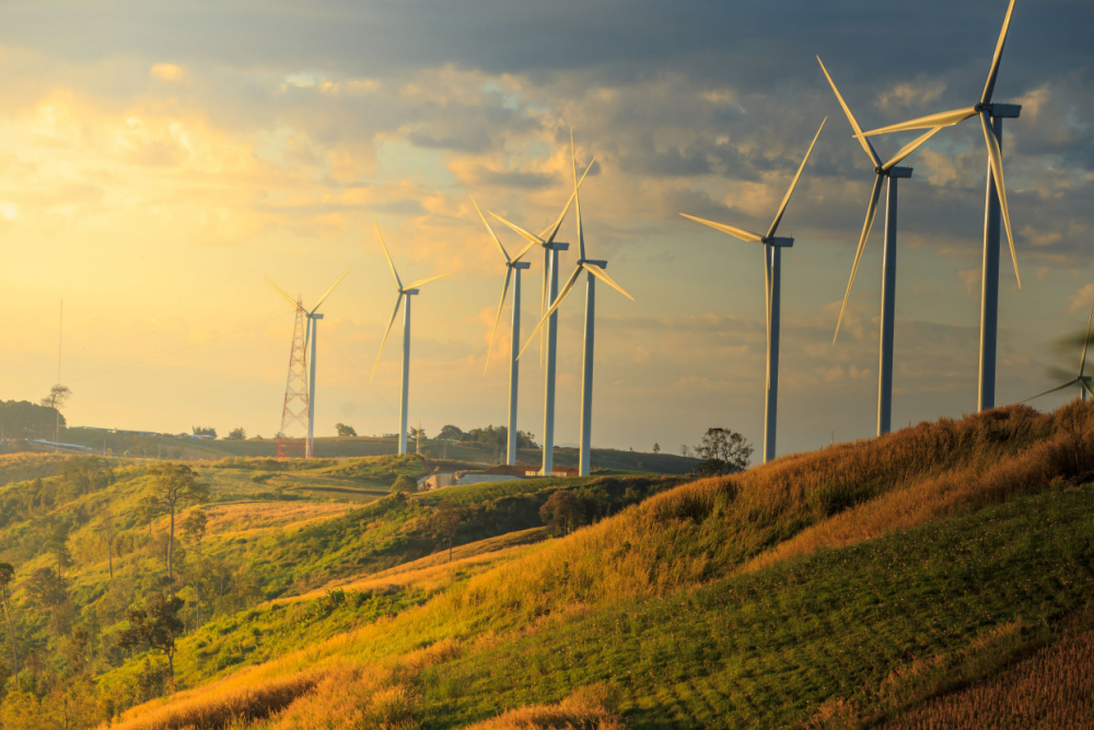 using wind power to mine bitcoin. solar farm on the hill during sunset 